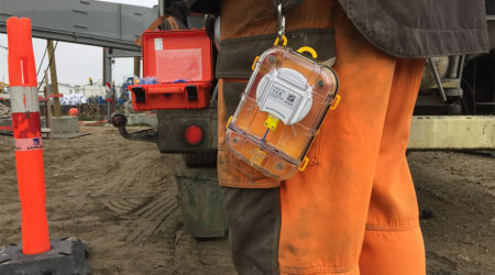 A Maturix Sensor is hanging off the pants of a construction worker.