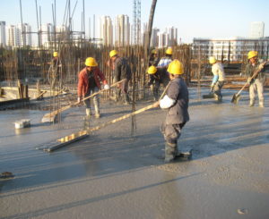 Several Chinese construction workers are concreting.