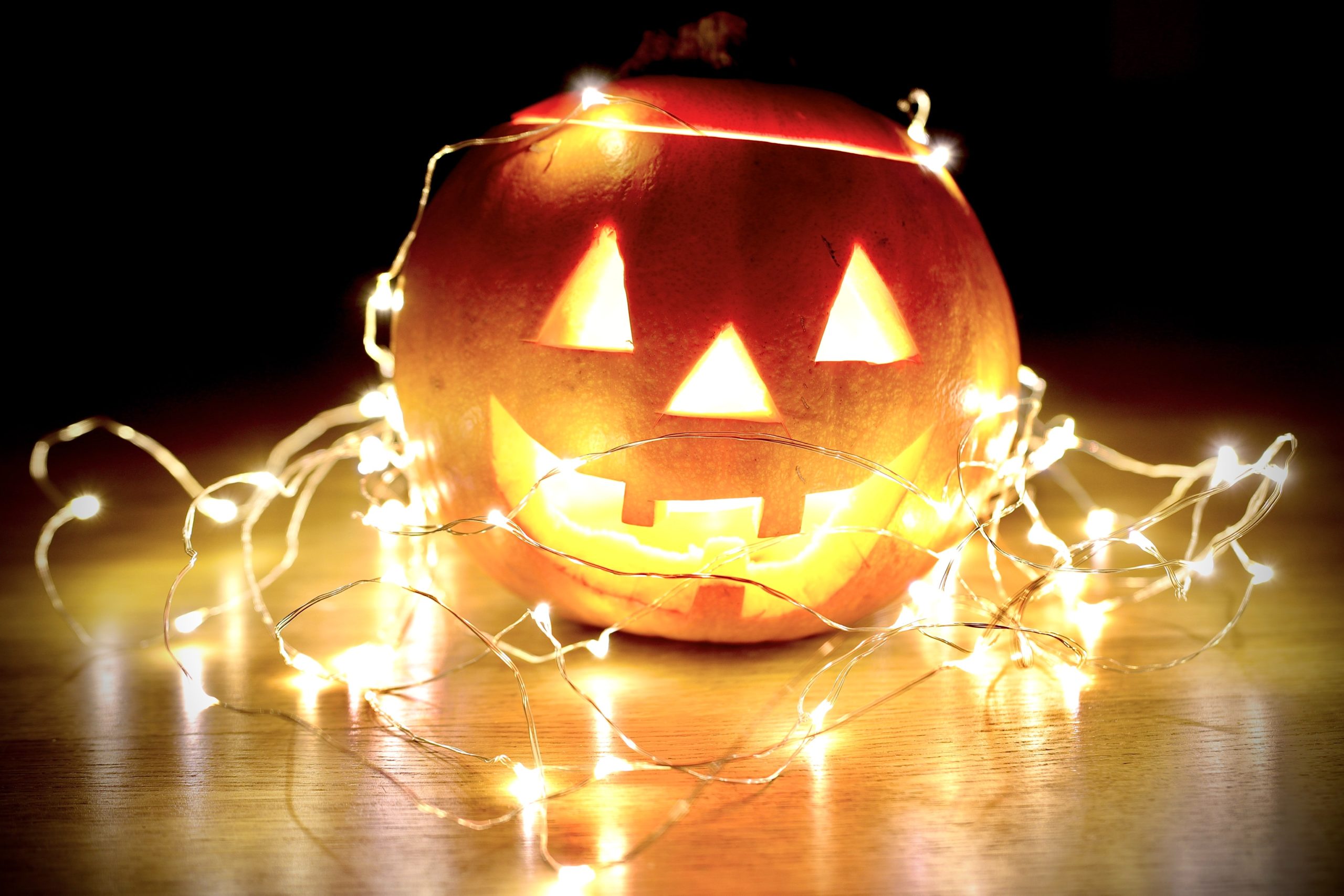A jack-o'-lantern is covered in lights.