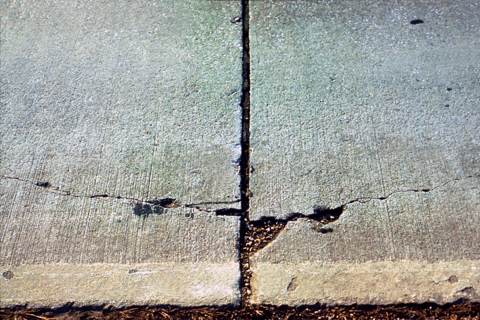Cracks are showing in the concrete pavement.