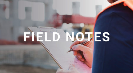 The title "Field Notes" is in the foreground while an image of a construction worker holding a note pad is in the background.