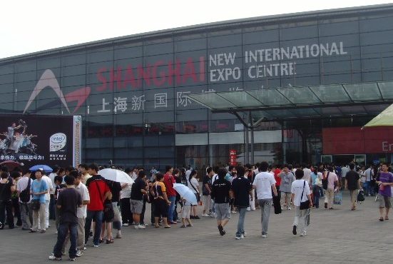 A crowd of people can be seen moving toward or around the Shanghai New International Expo Centre.